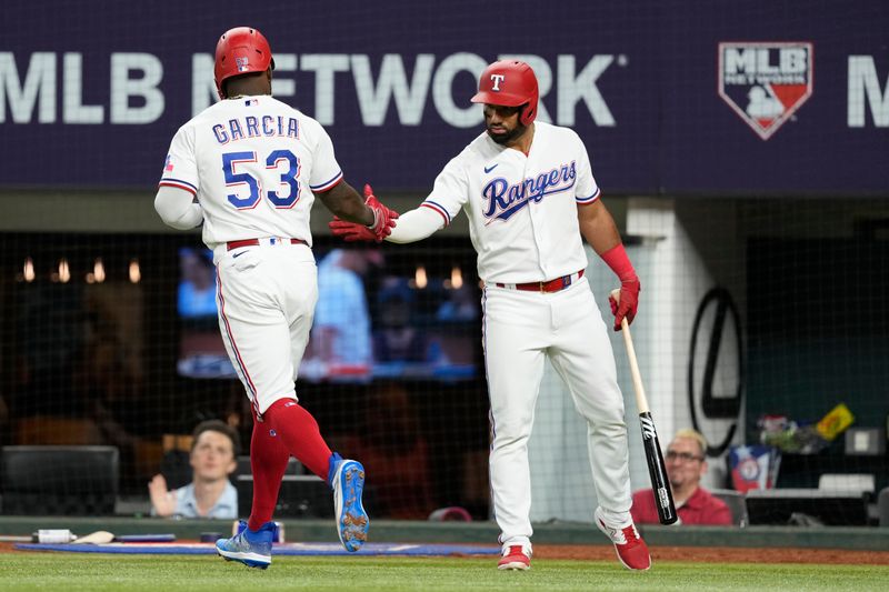 Jun 27, 2023; Arlington, Texas, USA; Texas Rangers right fielder Adolis Garcia (53) celebrates scoring a run with Texas Rangers left fielder Ezequiel Duran (right) against the Detroit Tigers during the sixth inning at Globe Life Field. Mandatory Credit: Jim Cowsert-USA TODAY Sports