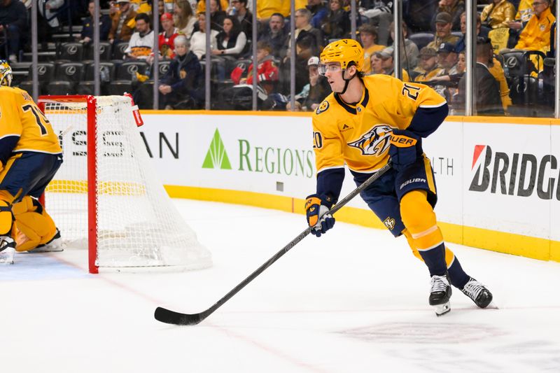 Jan 16, 2025; Nashville, Tennessee, USA;  Nashville Predators defenseman Justin Barron (20) clears the puck from behind his net against the Chicago Blackhawks during the second period at Bridgestone Arena. Mandatory Credit: Steve Roberts-Imagn Images