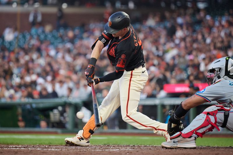Aug 31, 2024; San Francisco, California, USA; San Francisco Giants outfielder Mike Yastrzemski (5) hits into an RBI fielders choice against the Miami Marlins during the fifth inning at Oracle Park. Mandatory Credit: Robert Edwards-USA TODAY Sports