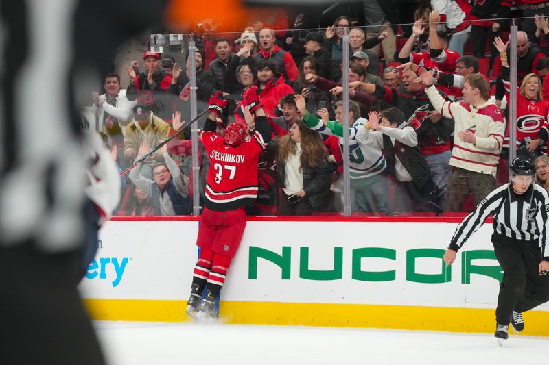 Dec 9, 2025; Raleigh, North Carolina, USA;  Carolina Hurricanes right wing Andrei Svechnikov (37) celebrates  center Jordan Staal (11) goal (not shown) against the Columbus Blue Jackets during the third period at Lenovo Center. Mandatory Credit: James Guillory-Imagn Images