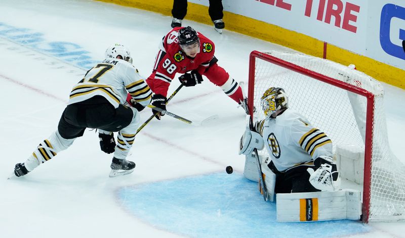 Oct 24, 2023; Chicago, Illinois, USA; Boston Bruins goaltender Jeremy Swayman (1) makes a save on Chicago Blackhawks center Connor Bedard (98) during the second period at United Center. Mandatory Credit: David Banks-USA TODAY Sports