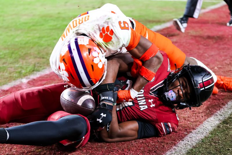 Nov 25, 2023; Columbia, South Carolina, USA; South Carolina Gamecocks defensive back Nick Emmanwori (21) and Clemson Tigers wide receiver Tyler Brown (6) wrestle for the ball in the second half at Williams-Brice Stadium. The play was ruled an interception by Emmanwori. Mandatory Credit: Jeff Blake-USA TODAY Sports