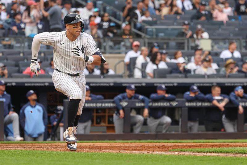 May 4, 2025; Bronx, New York, USA; New York Yankees right fielder Aaron Judge (99) doubles during the eighth inning against the Tampa Bay Rays at Yankee Stadium. Mandatory Credit: Vincent Carchietta-Imagn Images