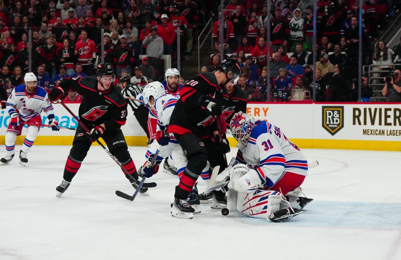 Mar 12, 2024; Raleigh, North Carolina, USA; Carolina Hurricanes center Sebastian Aho (20) can’t get the rebound shot past New York Rangers goaltender Igor Shesterkin (31) during the third period at PNC Arena. Mandatory Credit: James Guillory-USA TODAY Sports