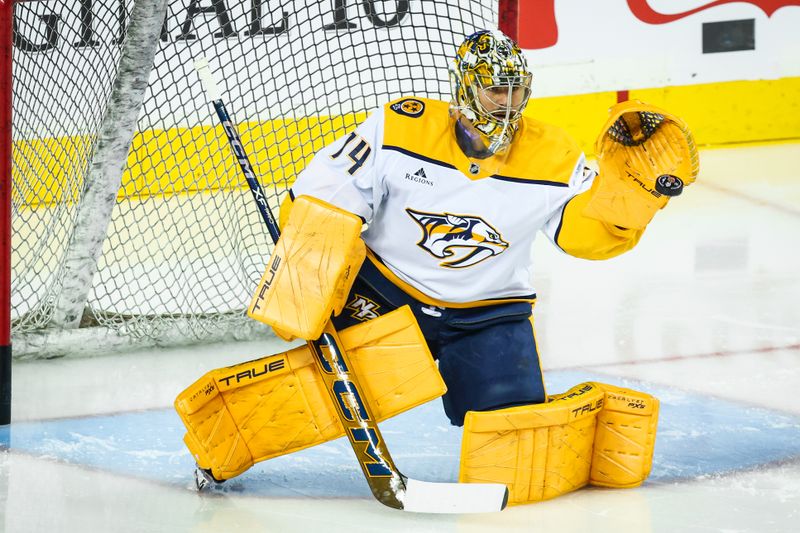 Nov 15, 2024; Calgary, Alberta, CAN; Nashville Predators goaltender Juuse Saros (74) during the warmup period at Scotiabank Saddledome. Mandatory Credit: Sergei Belski-Imagn Images