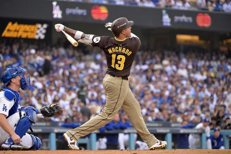 Oct 11, 2024; Los Angeles, California, USA; San Diego Padres third baseman Manny Machado (13) flies out in the second inning against the Los Angeles Dodgers during game five of the NLDS for the 2024 MLB Playoffs at Dodger Stadium. Mandatory Credit: Jayne Kamin-Oncea-Imagn Images