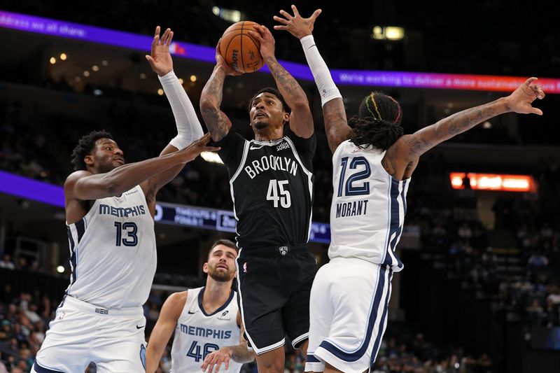 MEMPHIS, TENNESSEE - OCTOBER 30: Keon Johnson #45 of the Brooklyn Nets goes to the basket against Jaren Jackson Jr. #13 of the Memphis Grizzlies and Ja Morant #12 of the Memphis Grizzlies during the first half at FedExForum on October 30, 2024 in Memphis, Tennessee. NOTE TO USER: User expressly acknowledges and agrees that, by downloading and or using this photograph, User is consenting to the terms and conditions of the Getty Images License Agreement. (Photo by Justin Ford/Getty Images)