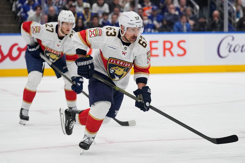 May 18, 2025; Toronto, Ontario, CAN; Florida Panthers forward Brad Marchand (63) and forward Eetu Luostarinen (27) break on a face-off against the Toronto Maple Leafs during the first period of game seven of the second round of the 2025 Stanley Cup Playoffs at Scotiabank Arena. Mandatory Credit: John E. Sokolowski-Imagn Images