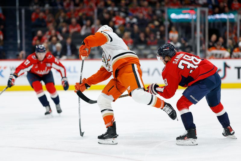 Jan 14, 2025; Washington, District of Columbia, USA; Washington Capitals defenseman Rasmus Sandin (38) disrupts the shot of Anaheim Ducks right wing Troy Terry (19) in the second period at Capital One Arena. Mandatory Credit: Geoff Burke-Imagn Images