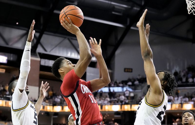 Mar 4, 2023; Columbia, Missouri, USA; Mississippi Rebels guard Matthew Murrell (11) shoot as Missouri Tigers forward Aidan Shaw (23) and guard D   Moi Hodge (5) defend during the second half at Mizzou Arena. Mandatory Credit: Denny Medley-USA TODAY Sports