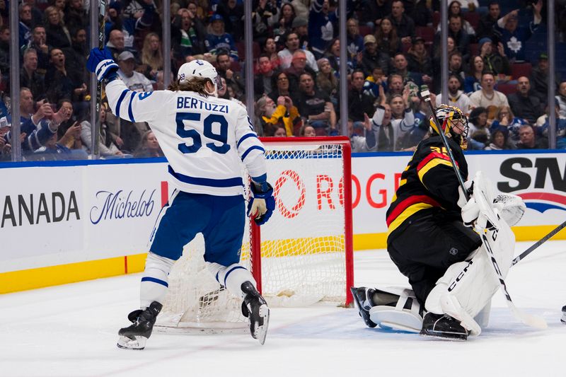 Jan 20, 2024; Vancouver, British Columbia, CAN; Toronto Maple Leafs forward Tyler Bertuzzi (59) celebrates a goal by forward William Nylander (not pictured) during the second period against Vancouver Canucks goalie Thatcher Demko (35) at Rogers Arena. Mandatory Credit: Bob Frid-USA TODAY Sports