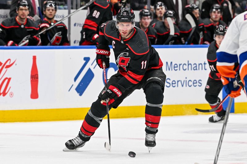 Mar 19, 2024; Elmont, New York, USA; Carolina Hurricanes center Jordan Staal (11) skates with the puck against the New York Islanders during the first period at UBS Arena. Mandatory Credit: Dennis Schneidler-USA TODAY Sports