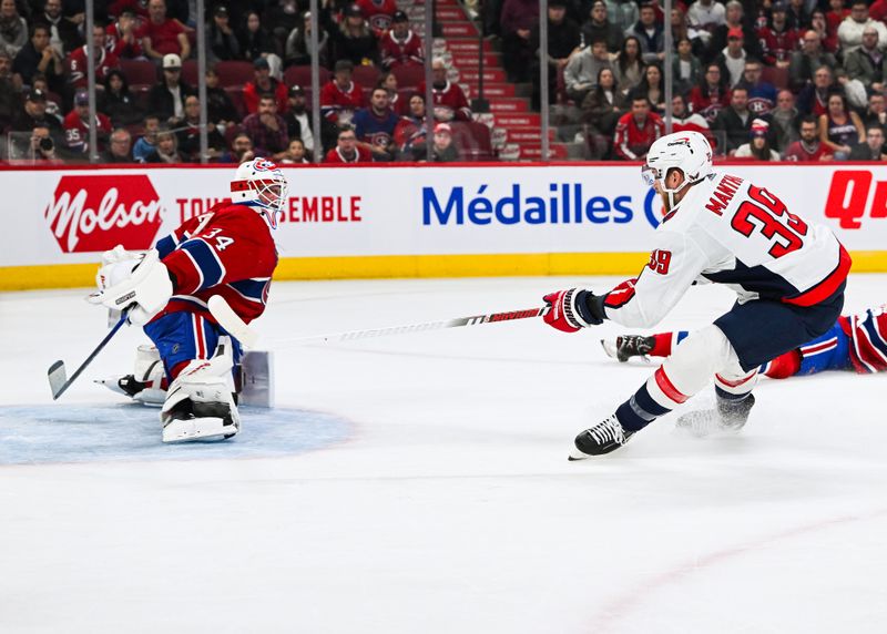 Oct 21, 2023; Montreal, Quebec, CAN; Montreal Canadiens goalie Jake Allen (34) makes a save against Washington Capitals right wing Anthony Mantha (39) during the first period at Bell Centre. Mandatory Credit: David Kirouac-USA TODAY Sports