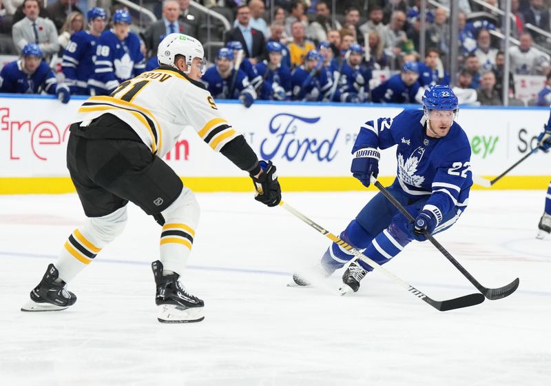 Nov 5, 2024; Toronto, Ontario, CAN; Toronto Maple Leafs defenseman Jake McCabe (22) battles with Boston Bruins defenseman Nikita Zadorov (91) during the first period at Scotiabank Arena. Mandatory Credit: Nick Turchiaro-Imagn Imagess