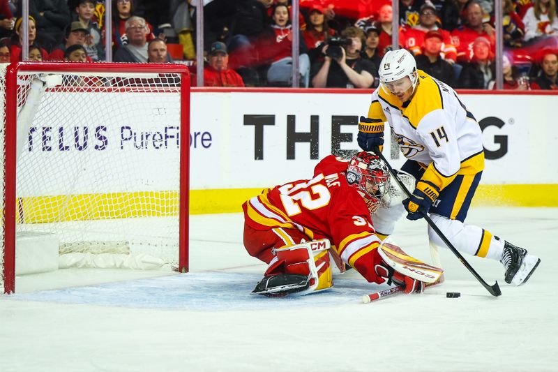 Nov 15, 2024; Calgary, Alberta, CAN; Calgary Flames goaltender Dustin Wolf (32) makes a save against Nashville Predators center Gustav Nyquist (14) during the first period at Scotiabank Saddledome. Mandatory Credit: Sergei Belski-Imagn Images