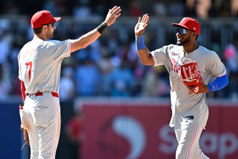 Apr 28, 2024; San Diego, California, USA; Philadelphia Phillies shortstop Trea Turner (7) and center fielder Johan Rojas (right) celebrate on the field after defeating the San Diego Padres at Petco Park. Mandatory Credit: Orlando Ramirez-USA TODAY Sports