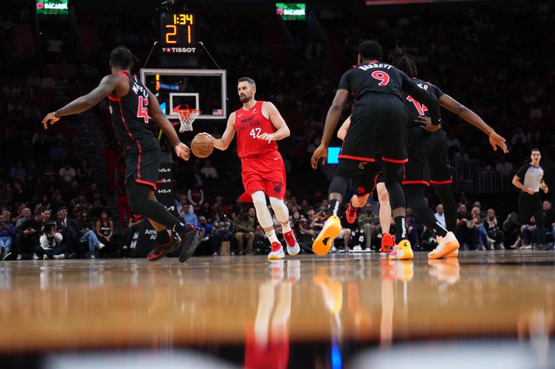 MIAMI, FLORIDA - DECEMBER 12: Kevin Love #42 of the Miami Heat dribbles the ball up the court against the Toronto Raptors during the first quarter at Kaseya Center on December 12, 2024 in Miami, Florida. NOTE TO USER: User expressly acknowledges and agrees that, by downloading and or using this Photograph, user is consenting to the terms and conditions of the Getty Images License Agreement. (Photo by Rich Storry/Getty Images)