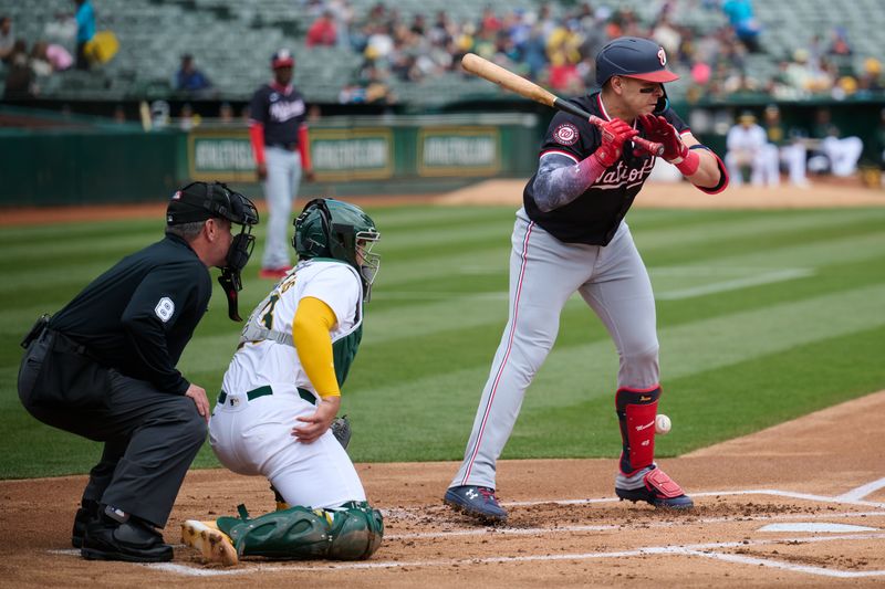Apr 14, 2024; Oakland, California, USA; Washington Nationals first baseman Joey Meneses (45) is hit by a pitch against the Oakland Athletics during the first inning at Oakland-Alameda County Coliseum. Mandatory Credit: Robert Edwards-USA TODAY Sports
