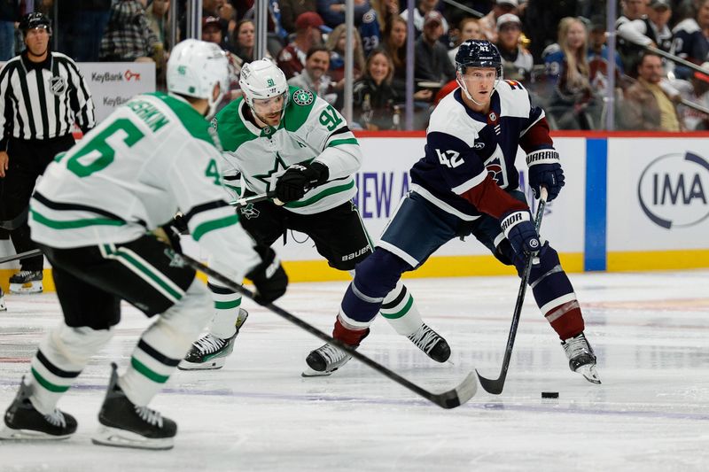 Oct 11, 2025; Denver, Colorado, USA; Colorado Avalanche defenseman Josh Manson (42) controls the puck under pressure from Dallas Stars center Tyler Seguin (91) and defenseman Ilya Lyubushkin (46) in the second period at Ball Arena. Mandatory Credit: Isaiah J. Downing-Imagn Images