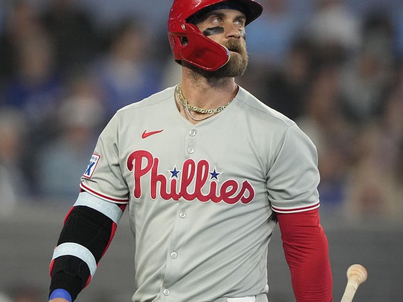 Jun 5, 2025; Toronto, Ontario, CAN; Philadelphia Phillies first baseman Bryce Harper (3) looks up at the scoreboard after striking out against the Toronto Blue Jays during the eighth inning at Rogers Centre. Mandatory Credit: John E. Sokolowski-Imagn Images