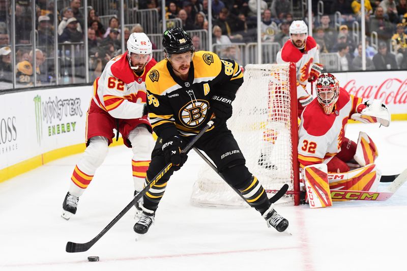 Nov 7, 2024; Boston, Massachusetts, USA;  Boston Bruins right wing David Pastrnak (88) controls the puck ahead of Calgary Flames defenseman Daniil Miromanov (62) during the third period at TD Garden. Mandatory Credit: Bob DeChiara-Imagn Images