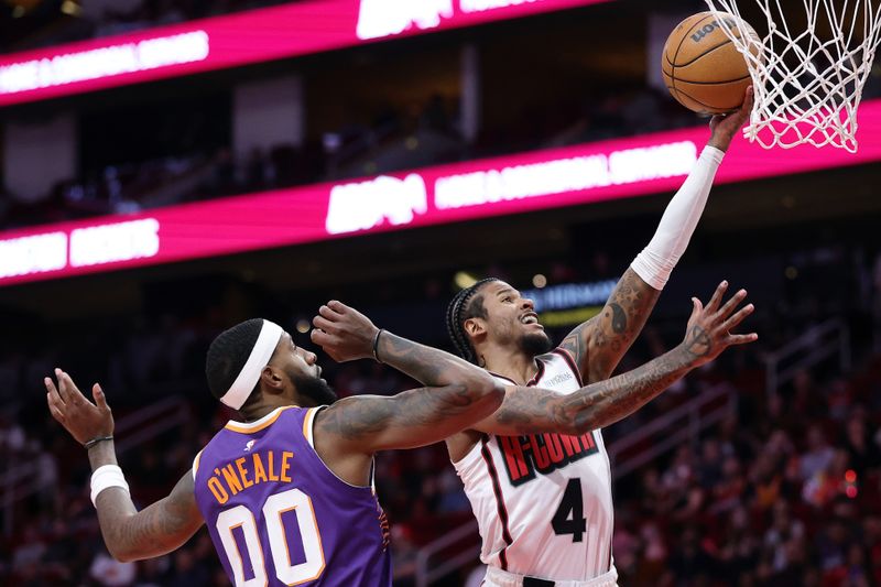 HOUSTON, TEXAS - FEBRUARY 12: Jalen Green #4 of the Houston Rockets shoots the ball against Royce O'Neale #00 of the Phoenix Suns during the first half at Toyota Center on February 12, 2025 in Houston, Texas. NOTE TO USER: User expressly acknowledges and agrees that, by downloading and or using this photograph, User is consenting to the terms and conditions of the Getty Images License Agreement. (Photo by Alex Slitz/Getty Images)