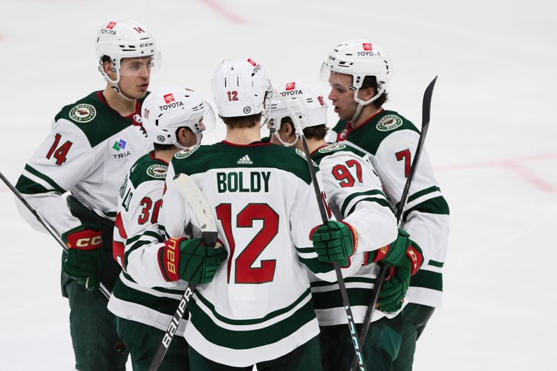 Jan 19, 2024; Sunrise, Florida, USA; Minnesota Wild left wing Kirill Kaprizov (97) celebrates with left wing Matt Boldy (12), right wing Mats Zuccarello (36), center Joel Eriksson Ek (14) and defenseman Brock Faber (7) after scoring against the Florida Panthers during the third period at Amerant Bank Arena. Mandatory Credit: Sam Navarro-USA TODAY Sports