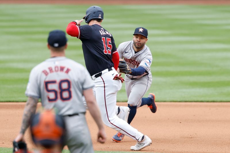 Apr 21, 2024; Washington, District of Columbia, USA; Houston Astros second baseman Jose Altuve (27) tags out Washington Nationals catcher Riley Adams (15) during the fourth inning at Nationals Park. Mandatory Credit: Geoff Burke-USA TODAY Sports