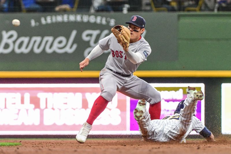 Apr 22, 2023; Milwaukee, Wisconsin, USA;  Milwaukee Brewers left fielder Christian Yelich (22) steals second base as Boston Red Sox shortstop Yu Chang (20) waits for the ball in the third inning at American Family Field. Mandatory Credit: Benny Sieu-USA TODAY Sports