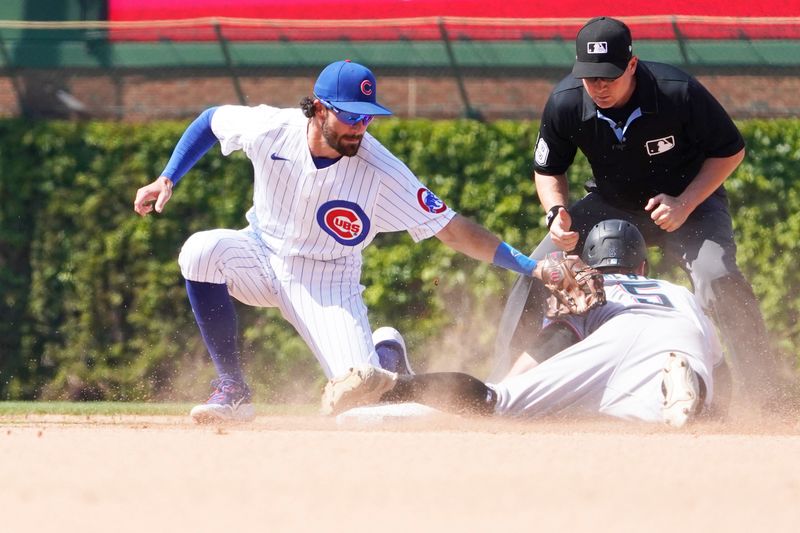 May 7, 2023; Chicago, Illinois, USA; Miami Marlins shortstop Jon Berti (5) steals second base as Chicago Cubs shortstop Dansby Swanson (7) takes the throw during the eighth inning at Wrigley Field. Mandatory Credit: David Banks-USA TODAY Sports