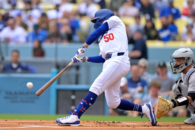 Jun 2, 2024; Los Angeles, California, USA;  Los Angeles Dodgers shortstop Mookie Betts (50) hits a solo home run in the first inning against the Colorado Rockies at Dodger Stadium. Mandatory Credit: Jayne Kamin-Oncea-USA TODAY Sports