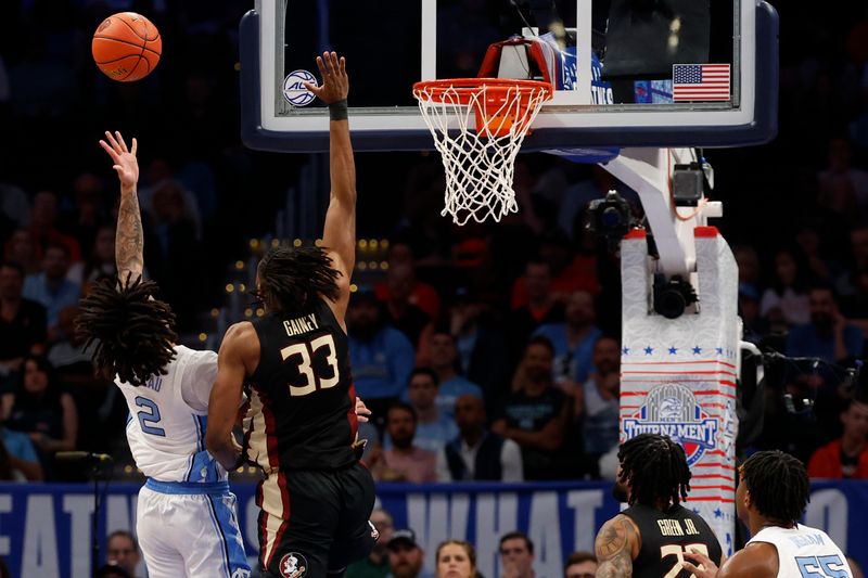 Mar 14, 2024; Washington, D.C., USA; North Carolina guard Elliot Cadeau (2) shoots the ball as Florida State forward Jaylan Gainey (33) defends in the first half at Capital One Arena. Mandatory Credit: Geoff Burke-USA TODAY Sports