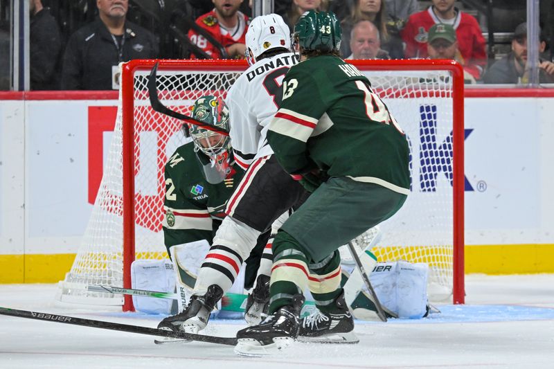 Sep 28, 2025; Saint Paul, Minnesota, USA;  Chicago Blackhawks forward Ryan Donato (8) puts the puck past Minnesota Wild goalie Filip Gustavsson (32) for a goal as forward Hunter Haight (43) defends during the third period at Xcel Energy Center. Mandatory Credit: Nick Wosika-Imagn Images
