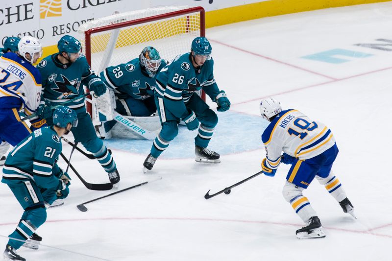 Nov 23, 2024; San Jose, California, USA;  San Jose Sharks defenseman Jack Thompson (26) defends Buffalo Sabres center Peyton Krebs (19) during the third period at SAP Center in San Jose. Mandatory Credit: John Hefti-Imagn Images