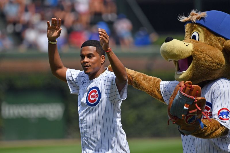 Aug 22, 2024; Chicago, Illinois, USA; American actor Cory Hardrict throws out the ceremonial first pitch prior to a game between the Chicago Cubs and the Detroit Tigers at Wrigley Field. Mandatory Credit: Patrick Gorski-USA TODAY Sports