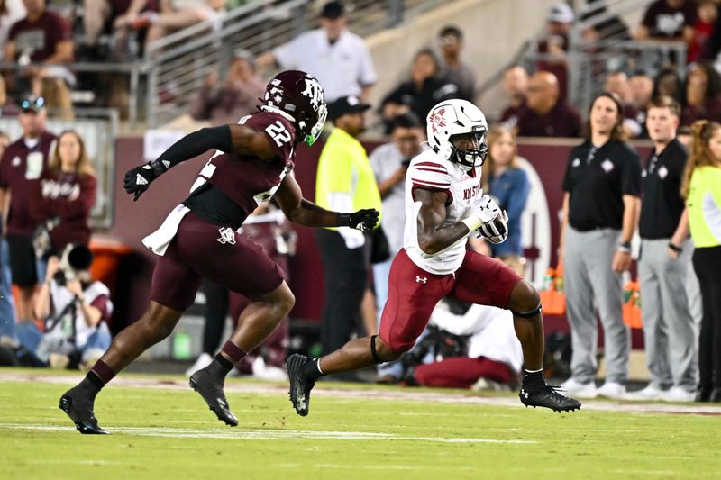 Nov 16, 2024; College Station, Texas, USA; New Mexico State Aggies running back Mike Washington (4) runs the ball during the second half as Texas A&M Aggies linebacker Solomon DeShields (22) defends at Kyle Field. Mandatory Credit: Maria Lysaker-Imagn Images 