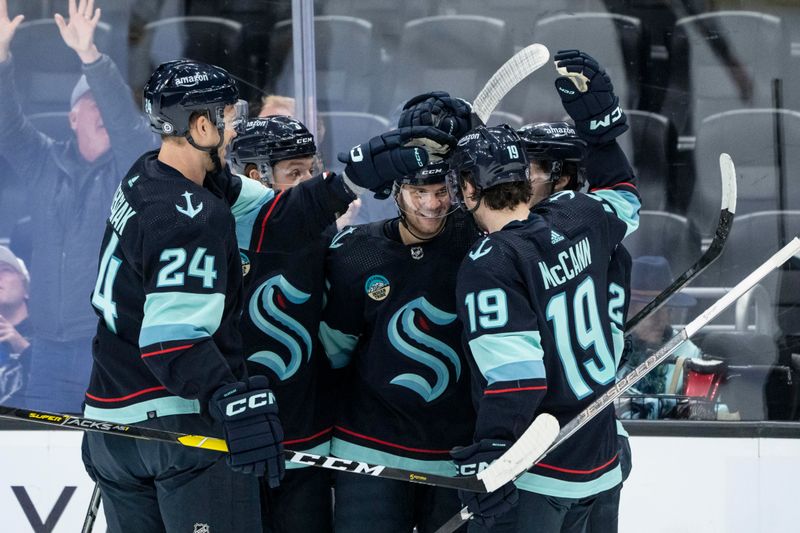 Mar 12, 2024; Seattle, Washington, USA; Seattle Krakendefenseman Jamie Oleksiak (24), defenseman Will Borgen (3), second from left, forward Andre Burakovsky (95), center, forward Tye Kartye (52) and forward Jared McCann (19) celebrate a goal against the Vegas Golden Knights during the second period at Climate Pledge Arena. Mandatory Credit: Stephen Brashear-USA TODAY Sports