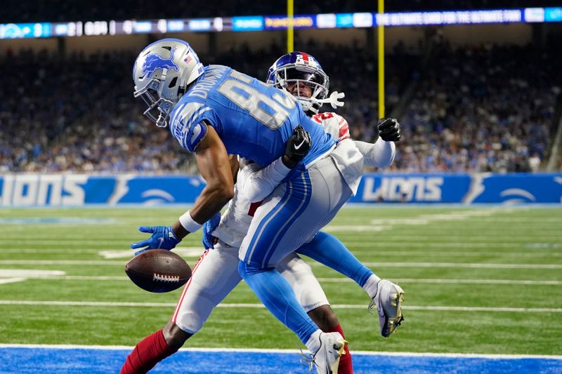 New York Giants cornerback Cor'Dale Flott (28) breaks up a pass intended for Detroit Lions wide receiver Dylan Drummond (83) during the first half of an NFL preseason football game, Friday, Aug. 11, 2023, in Detroit. (AP Photo/Paul Sancya)