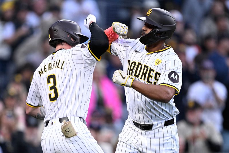 May 13, 2024; San Diego, California, USA; San Diego Padres second baseman Xander Bogaerts (right) is congratulated by center fielder Jackson Merrill (3) after hitting a home run against the Colorado Rockies during the second inning at Petco Park. Mandatory Credit: Orlando Ramirez-USA TODAY Sports