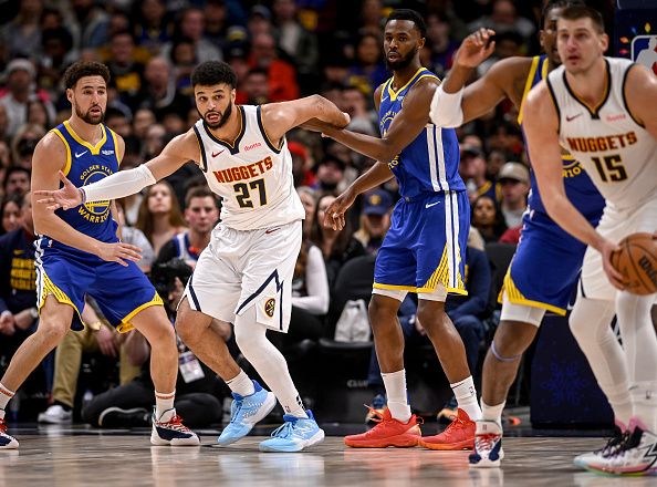 DENVER, CO - DECEMBER 25: Jamal Murray (27) of the Denver Nuggets look for a pass from Nikola Jokic (15) as Klay Thompson (11) and Andrew Wiggins (22) of the Golden State Warriors defend during the second quarter at Ball Arena in Denver on Monday, December 25, 2023. (Photo by AAron Ontiveroz/The Denver Post)