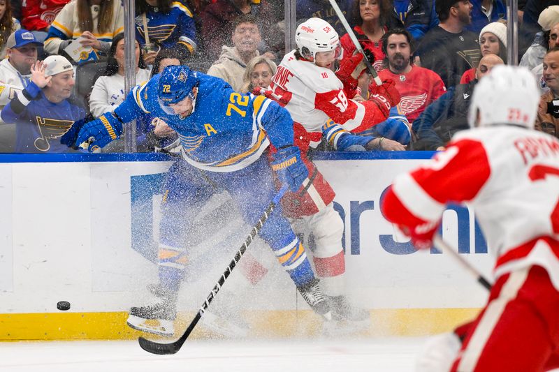 Oct 28, 2025; St. Louis, Missouri, USA; St. Louis Blues defenseman Justin Faulk (72) checks Detroit Red Wings center Emmitt Finnie (58) during the first period at Enterprise Center. Mandatory Credit: Jeff Curry-Imagn Images