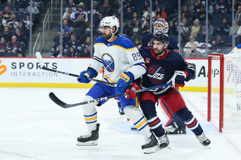 Jan 26, 2023; Winnipeg, Manitoba, CAN;  Buffalo Sabres forward Alex Tuch (89) jostles for position with Winnipeg Jets defenseman Dylan DeMelo (2) in front of Winnipeg Jets goalie Connor Hellebuyck (37) during the first period at Canada Life Centre. Mandatory Credit: Terrence Lee-USA TODAY Sports