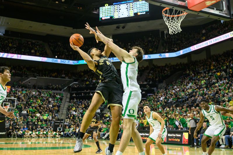 Jan 18, 2025; Eugene, Oregon, USA; Purdue Boilermakers forward Trey Kaufman-Renn (4) shoots the ball inside against Oregon Ducks center Nate Bittle (32) during the second half at Matthew Knight Arena. Mandatory Credit: Craig Strobeck-Imagn Images