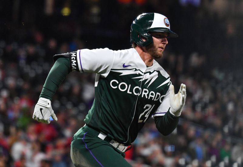 May 13, 2023; Denver, Colorado, USA; Colorado Rockies third baseman Ryan McMahon (24) hits a double in the eighth inning against the Philadelphia Phillies at Coors Field. Mandatory Credit: John Leyba-USA TODAY Sports