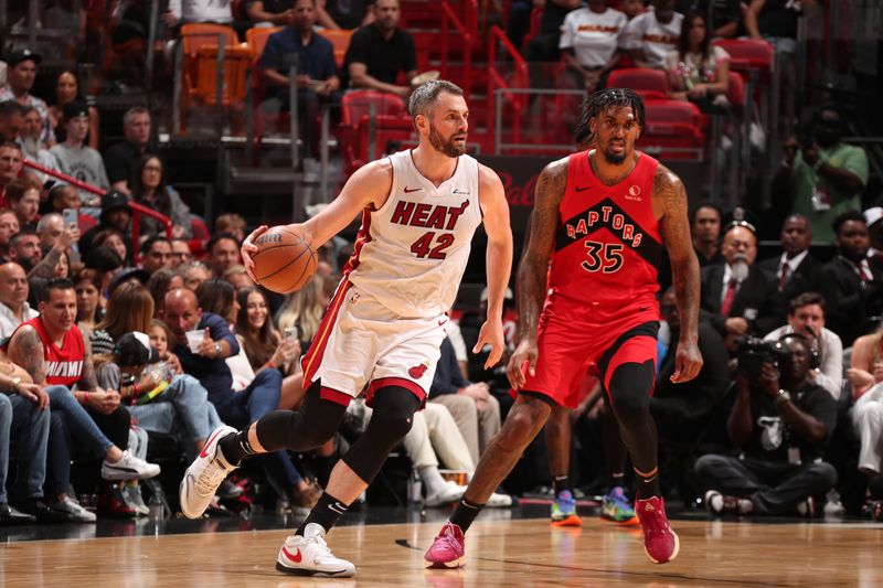 MIAMI, FL - APRIL 12:  Kevin Love #42 of the Miami Heat dribbles the ball during the game against the Toronto Raptors on April 12, 2024 at Kaseya Center in Miami, Florida. NOTE TO USER: User expressly acknowledges and agrees that, by downloading and or using this Photograph, user is consenting to the terms and conditions of the Getty Images License Agreement. Mandatory Copyright Notice: Copyright 2024 NBAE (Photo by Issac Baldizon/NBAE via Getty Images)