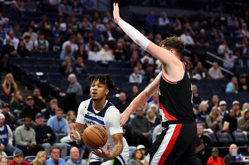 MINNEAPOLIS, MINNESOTA - NOVEMBER 08: Terrence Shannon Jr. #00 of the Minnesota Timberwolves passes the ball against Donovan Clingan #23 of the Portland Trail Blazers in the fourth quarter at Target Center on November 08, 2024 in Minneapolis, Minnesota. The Timberwolves defeated the Trail Blazers 127-102 NOTE TO USER: User expressly acknowledges and agrees that, by downloading and or using this photograph, User is consenting to the terms and conditions of the Getty Images License Agreement. (Photo by David Berding/Getty Images)