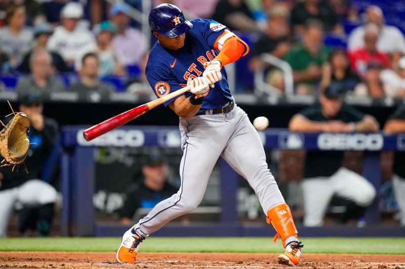 Aug 14, 2023; Miami, Florida, USA; Houston Astros shortstop Jeremy Pena (3) hits a single against the Miami Marlins during the second inning at loanDepot Park. Mandatory Credit: Rich Storry-USA TODAY Sports