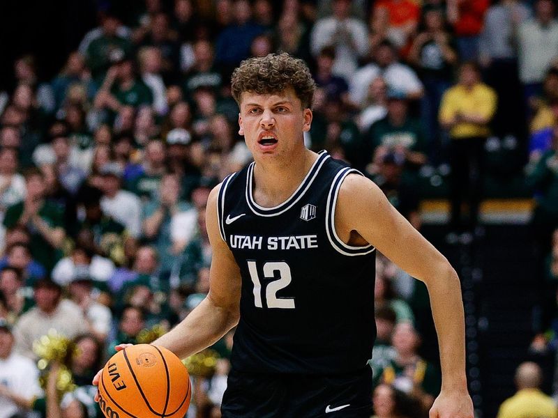 Feb 17, 2024; Fort Collins, Colorado, USA; Utah State Aggies guard Mason Falslev (12) controls the ball in the first half against the Colorado State Rams at Moby Arena. Mandatory Credit: Isaiah J. Downing-USA TODAY Sports