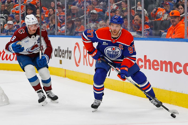 Nov 8, 2025; Edmonton, Alberta, CAN; Edmonton Oilers forward Connor McDavid (97) looks to make a pass in front og Colorado Avalanche defensemen Cale Makar (8) during the third period at Rogers Place. Mandatory Credit: Perry Nelson-Imagn Images
