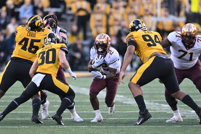 Oct 21, 2023; Iowa City, Iowa, USA; Minnesota Golden Gophers running back Sean Tyler (2) runs the ball as Iowa Hawkeyes defensive back Quinn Schulte (30) and defensive lineman Yahya Black (94) and defensive lineman Deontae Craig (45) attempt to make the tackle as offensive lineman Martes Lewis (71) blocks during the fourth quarter at Kinnick Stadium. Mandatory Credit: Jeffrey Becker-USA TODAY Sports